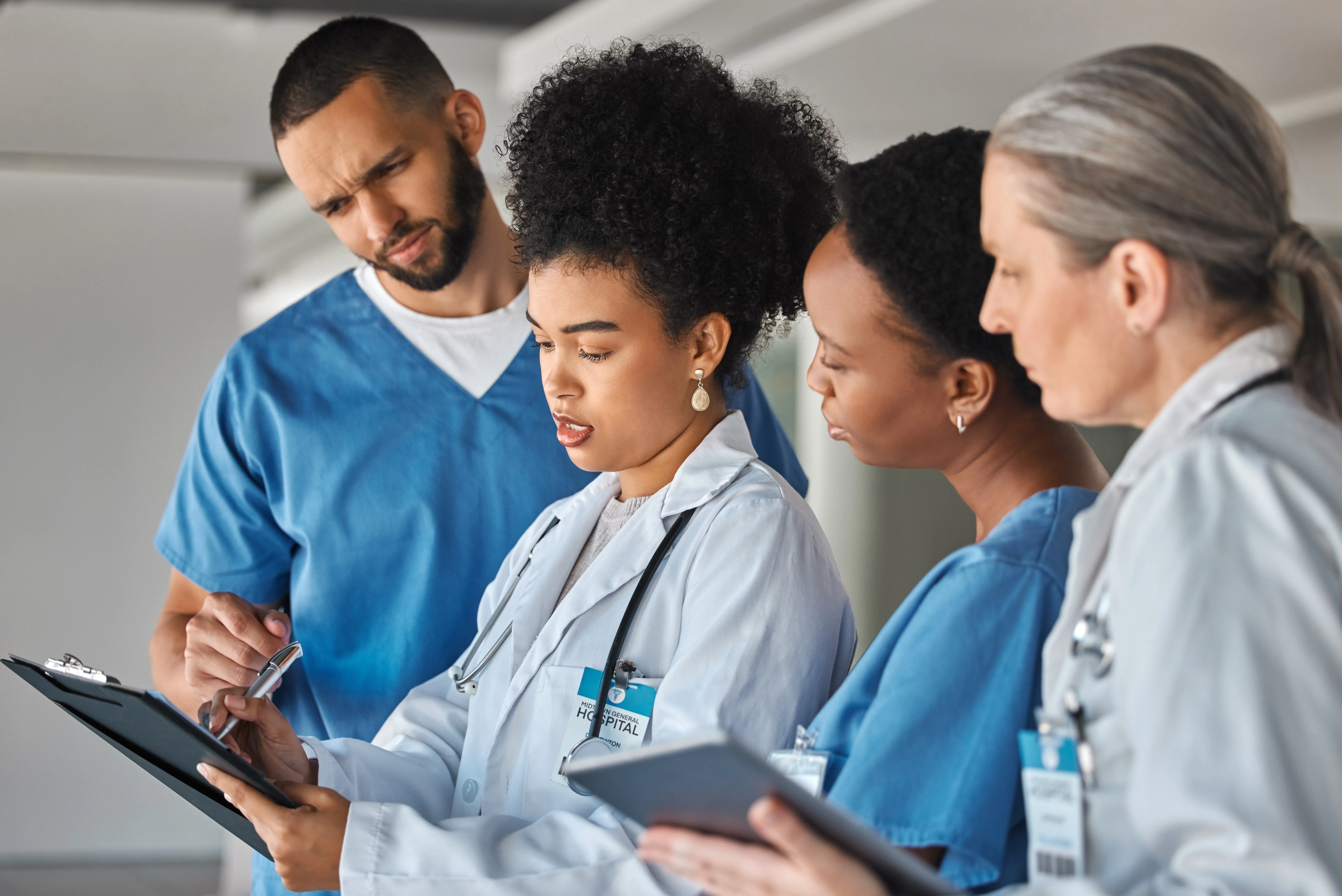 Doctor schedule, meeting and medical worker talking to hospital team about healthcare agenda. Group of medicine employees in communication about collaboration and teamwork on paper in clinic.